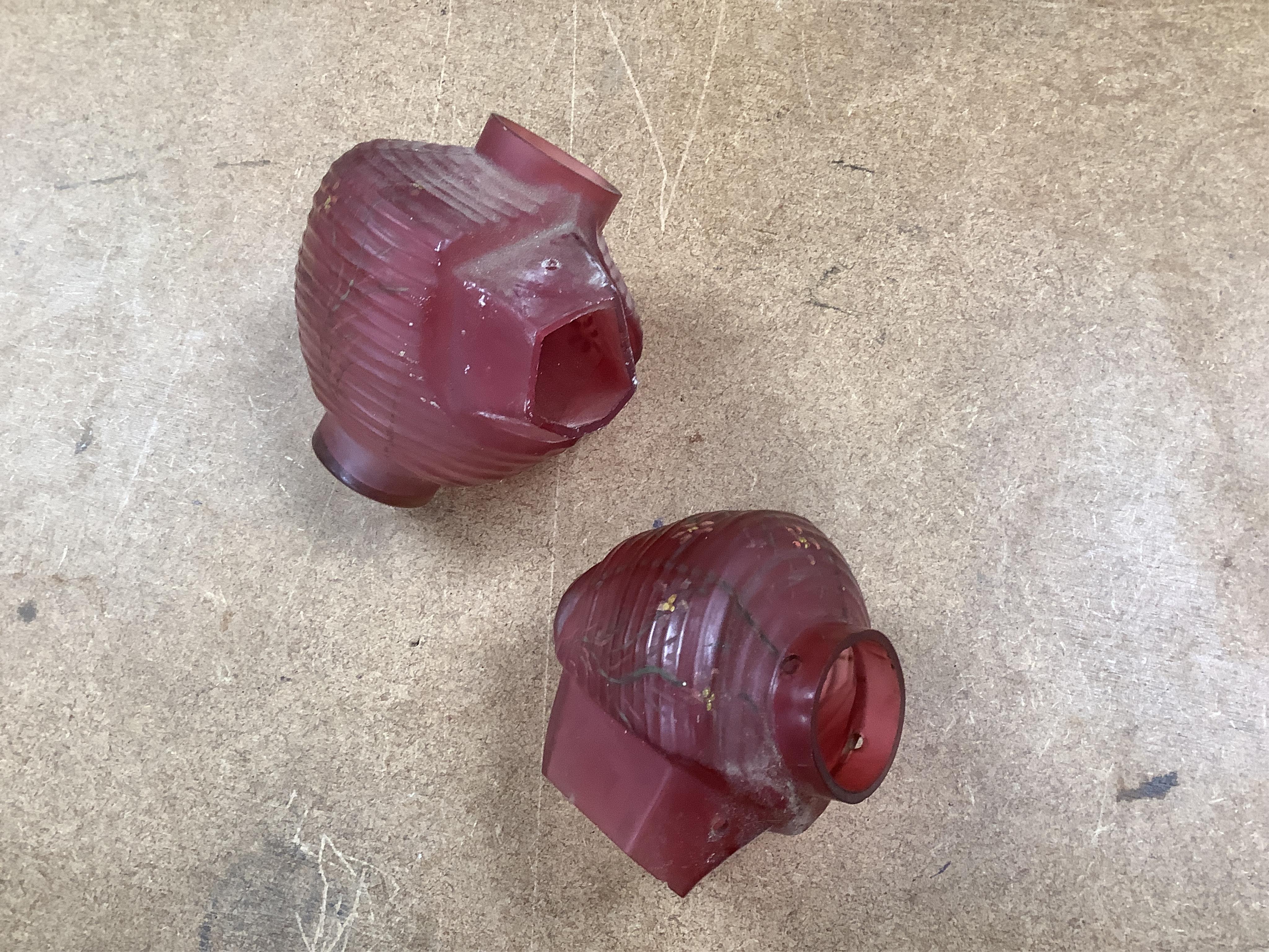 A Goldscheider cold-painted terracotta figural lamp with two cranberry glass shades, 55cm high